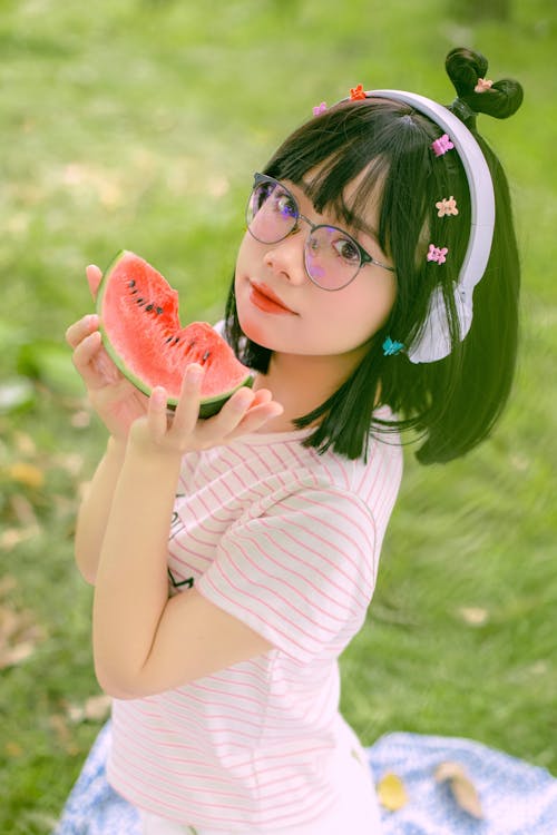 Free Girl in Headphones Eating Watermelon Stock Photo