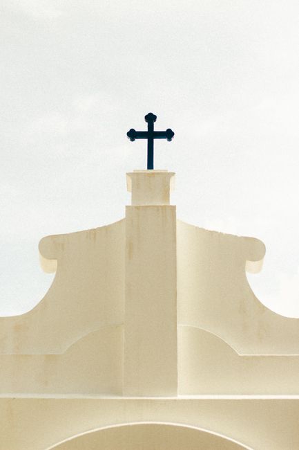 A simple church facade with a prominent holy cross, symbolizing Christianity in Brazil.