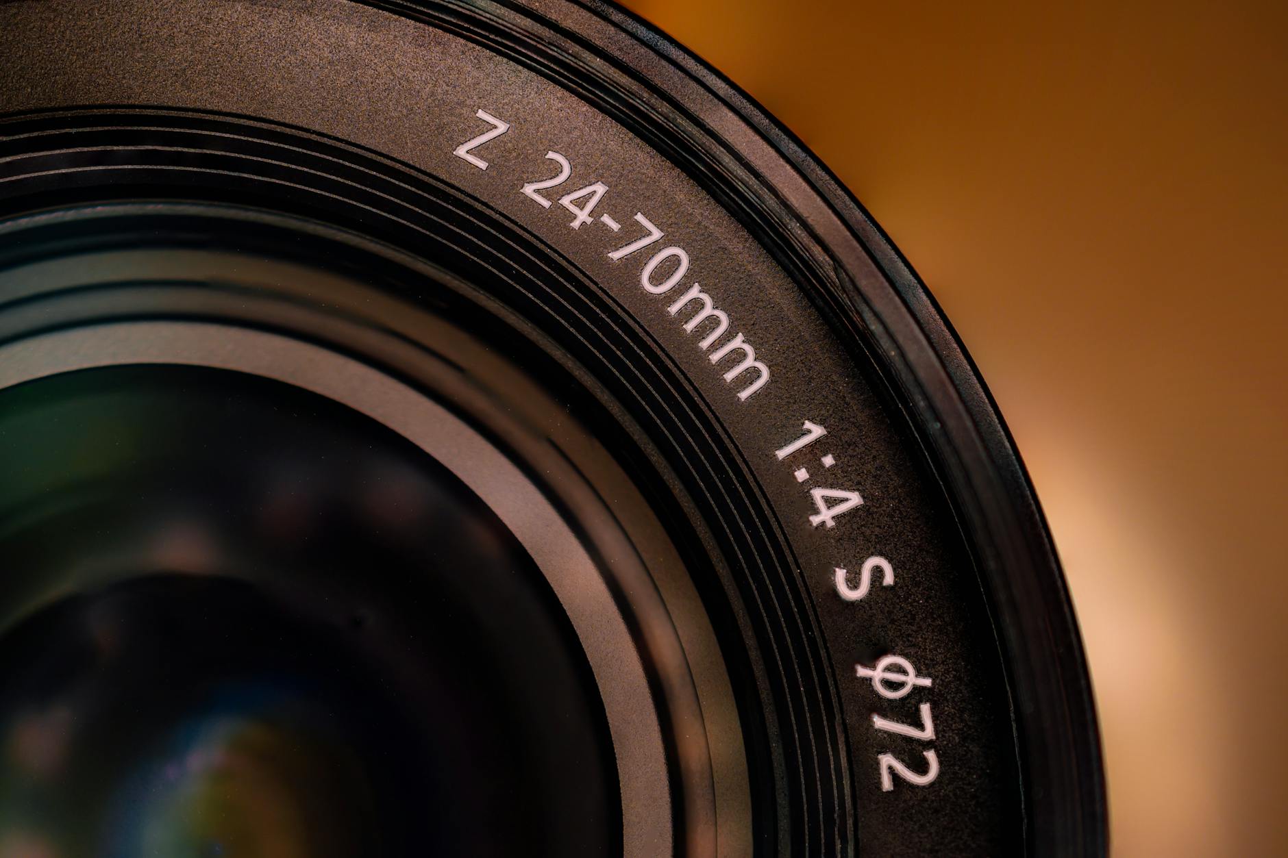 Detailed close-up of a camera lens showing 24-70mm markings, ideal for photography themes.
