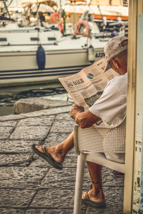 Man Reading Newspaper in Seaside