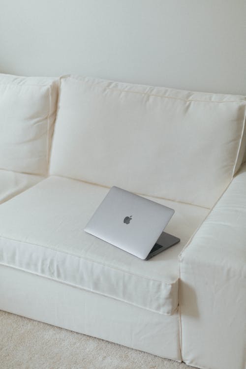 A Laptop on a Light Sofa 