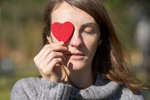 Free Woman Holding Heart Shaped Cut Out Stock Photo