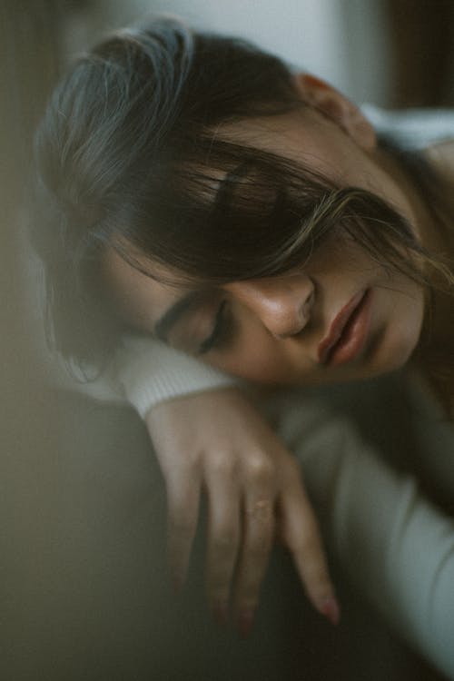 Beautiful Brunette Woman Sleeping on Folded Forearms