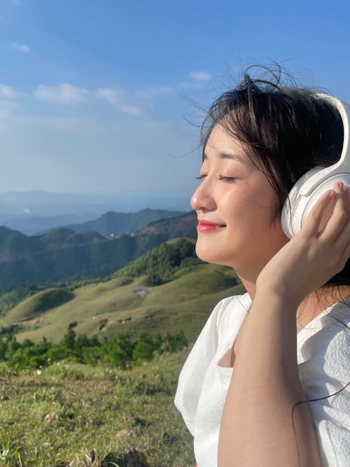 Free Smiling Woman Listening to Music with Eyes Closed Stock Photo