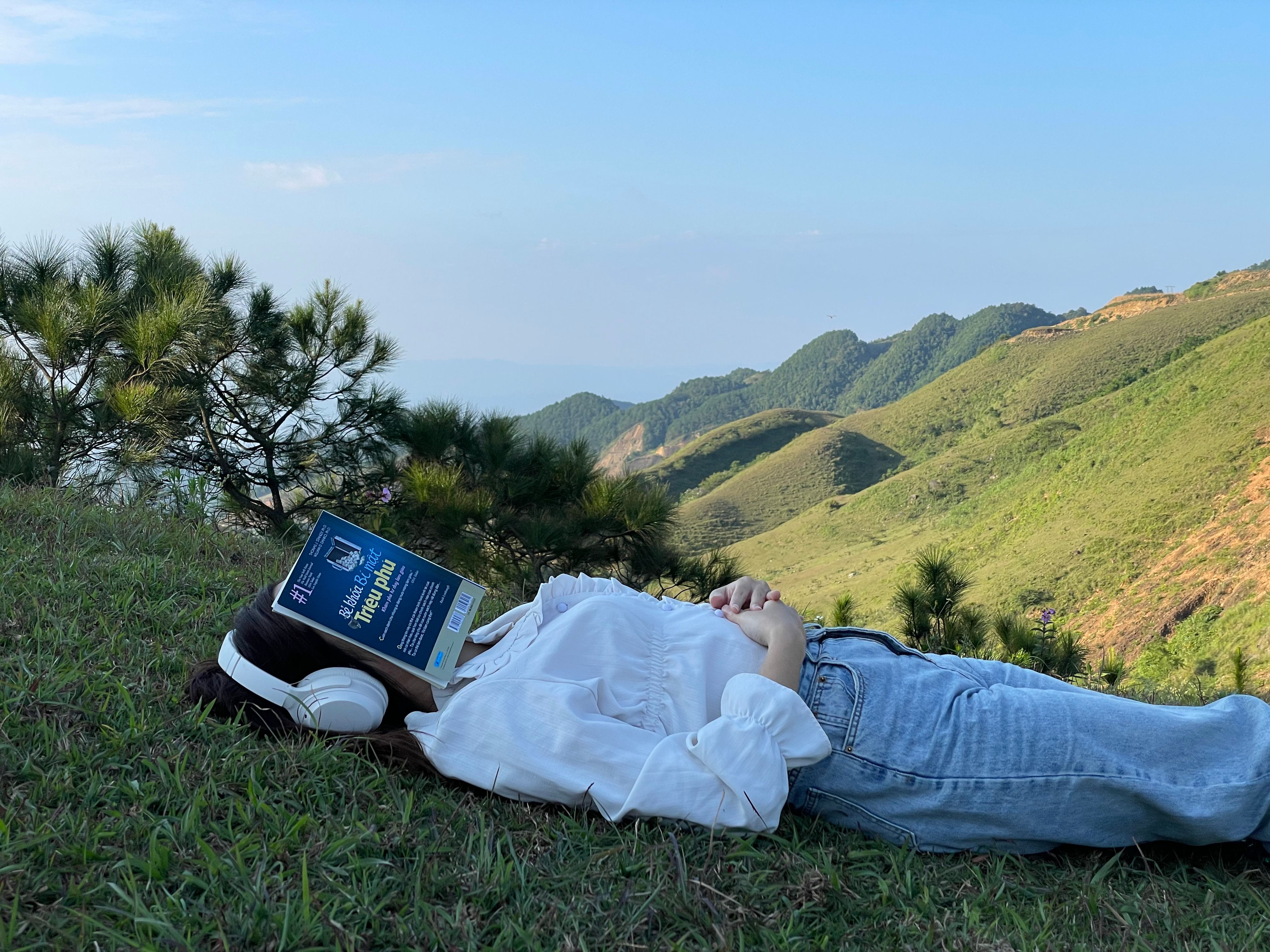 Woman Lying Down with Book on Grass