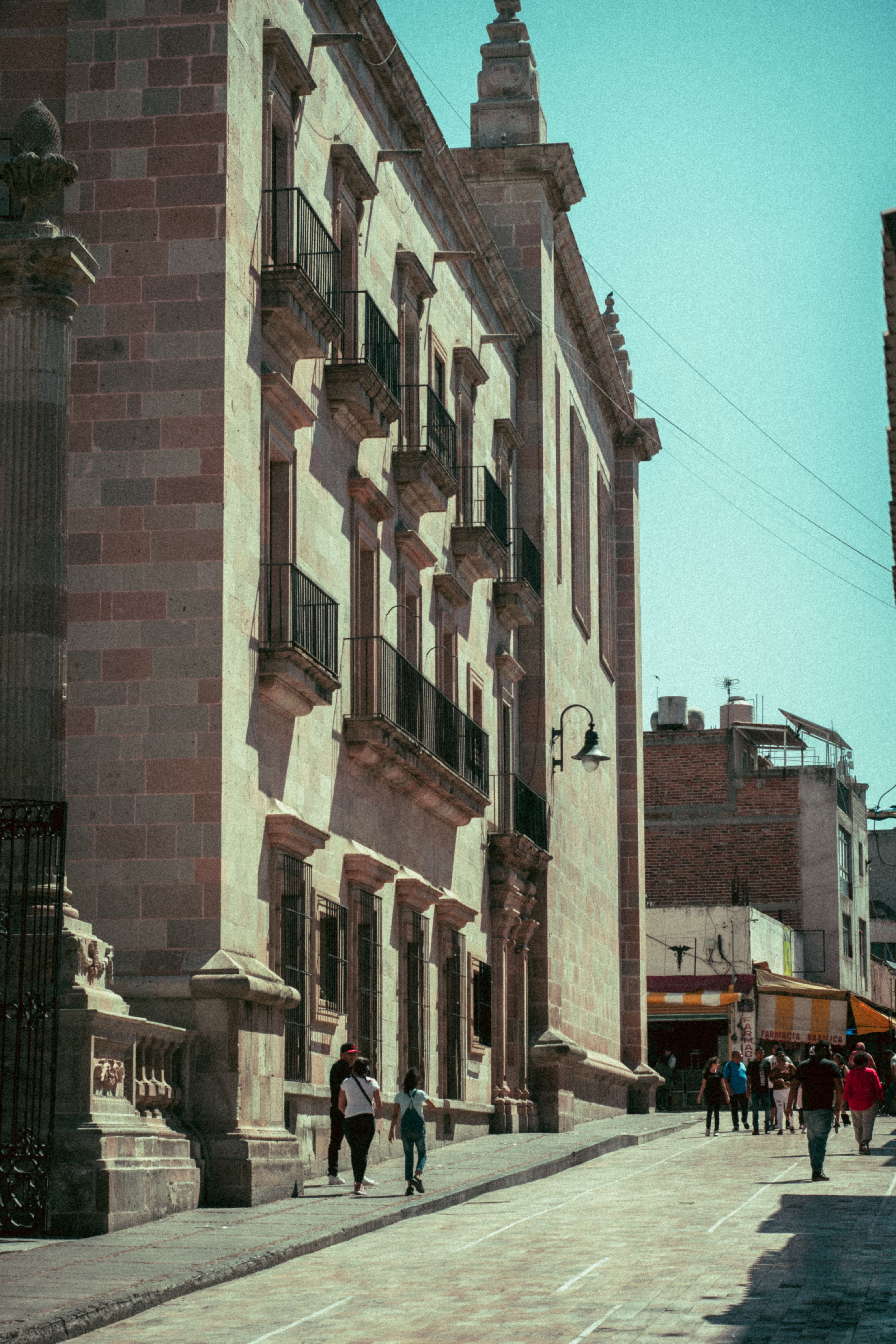 A vibrant sunlit street scene showcasing historic architecture and urban life - county heritage tourism