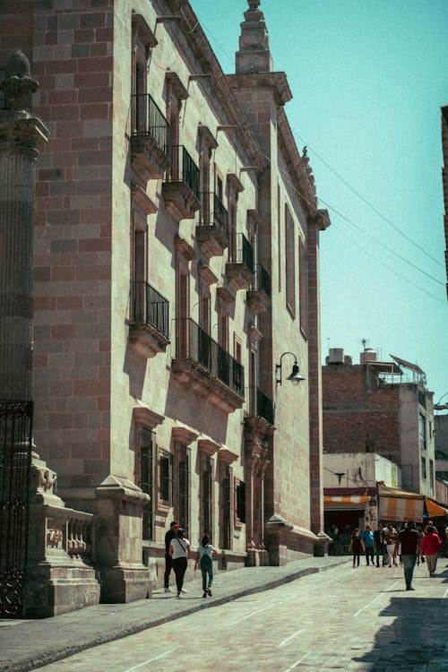 Sunlit Street near Building in Town