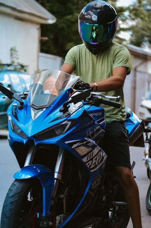 Man on Blue Motorcycle