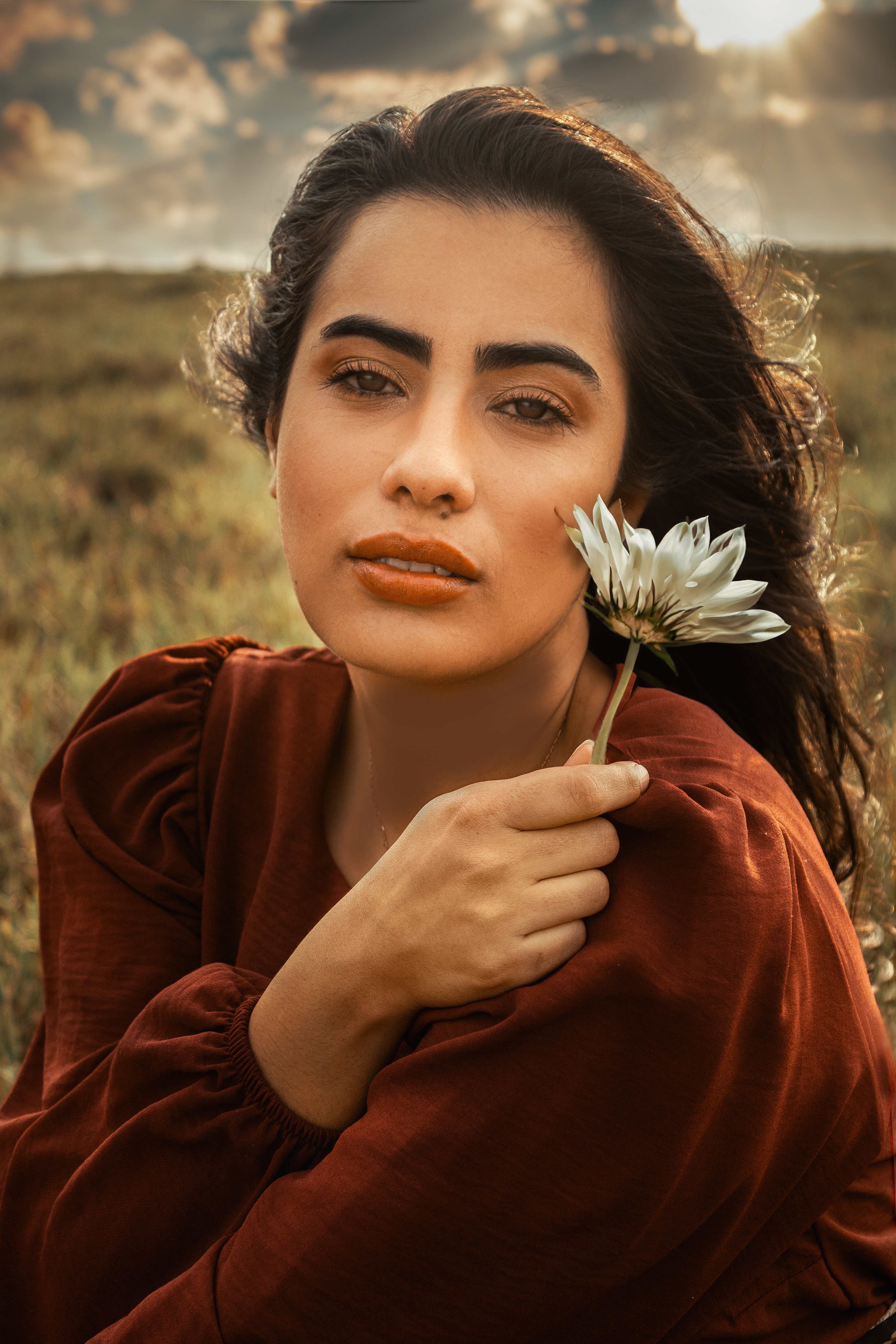 Young Woman in a Dress Sitting Outside and Holding a Flower · Free ...
