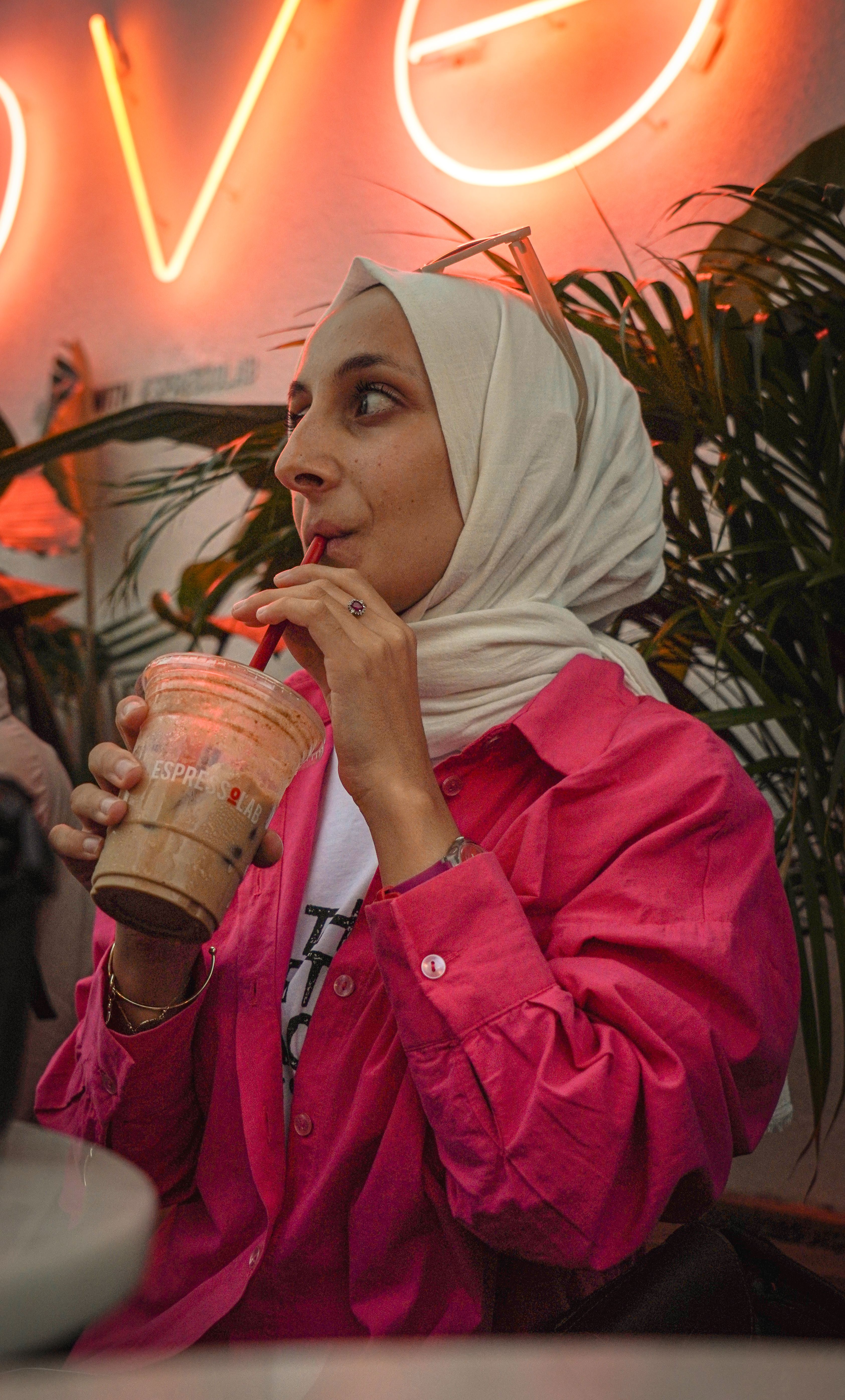 Woman in Hijab and Pink Shirt Drinking Coffee · Free Stock Photo