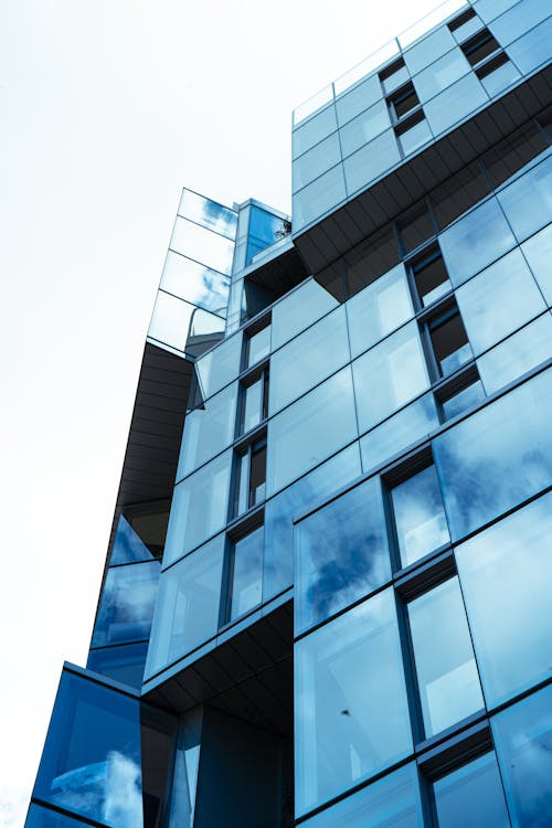 Low Angle Shot of a Modern Building with a Glass Facade 