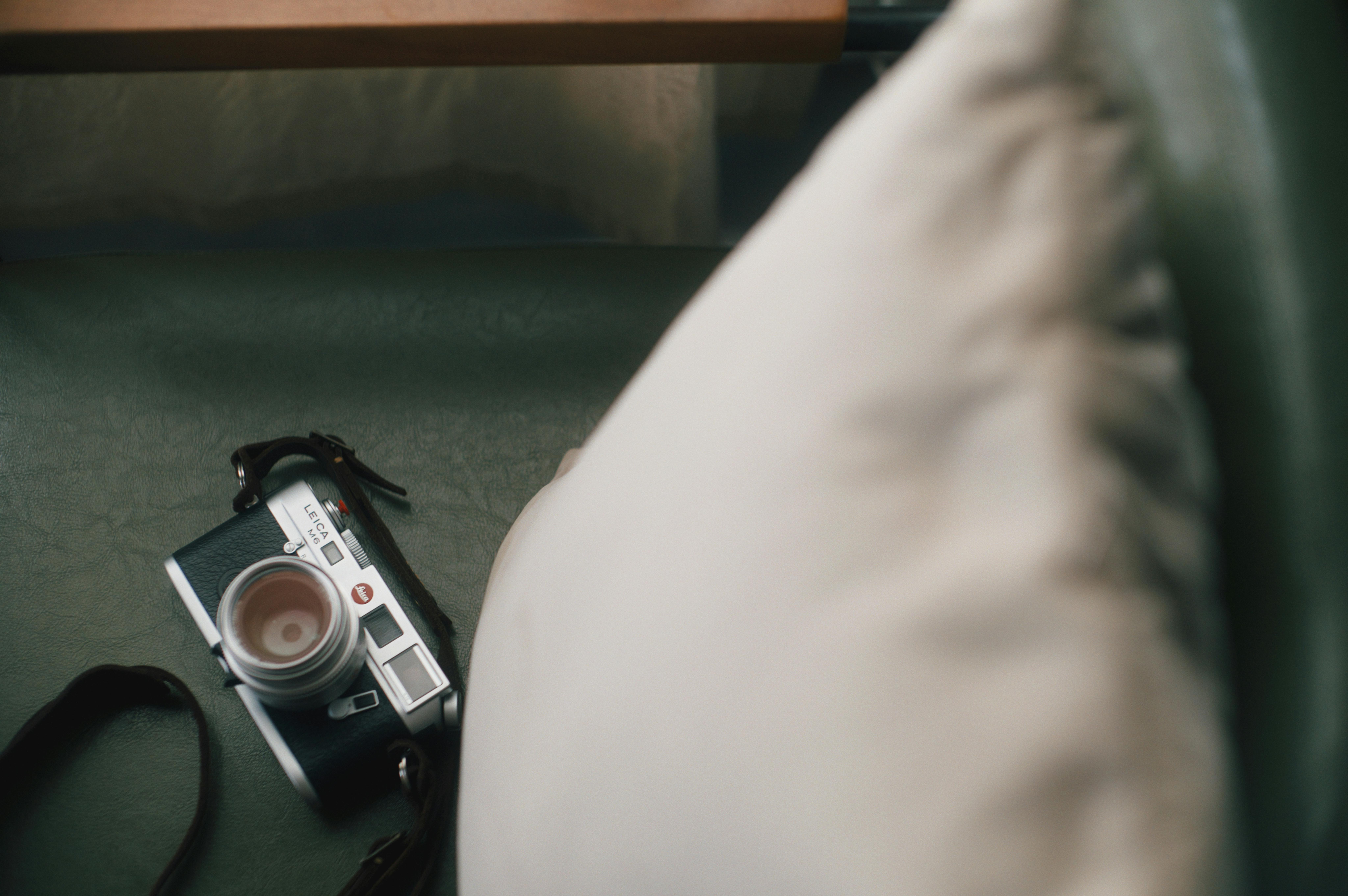 A vintage camera resting on a cushion, showcasing a cozy retro aesthetic.