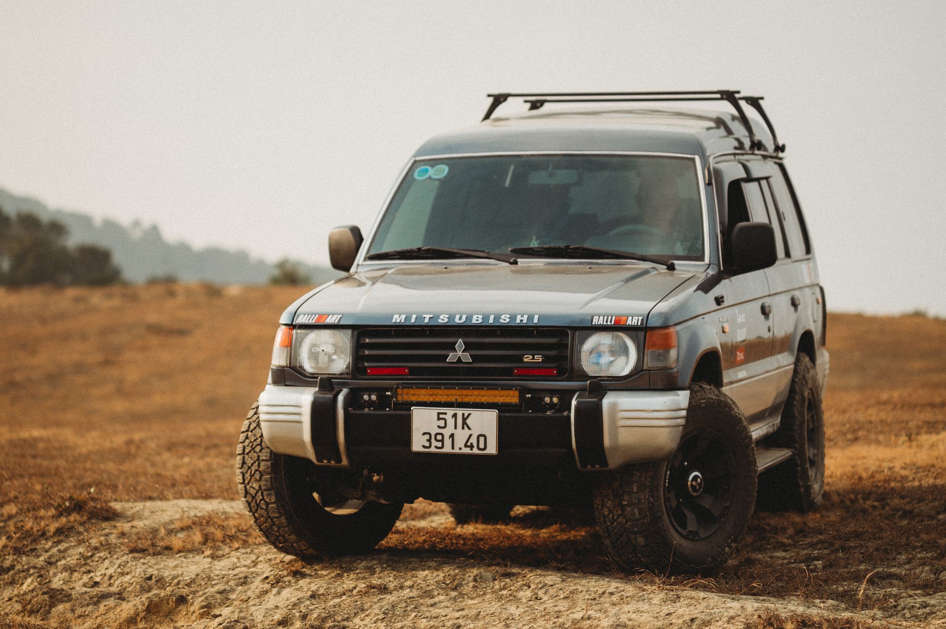 A Mitsubishi Pajero 4x4 vehicle parked in a rural area, ideal for offroad adventures.