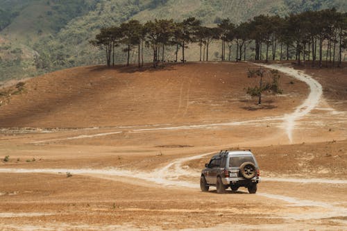 View of a Mitsubishi Pajero Driving on a Dirt Road