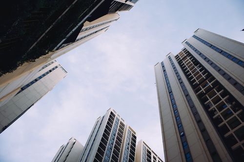 Free Dynamic low-angle view of towering modern skyscrapers under a clear blue sky. Stock Photo