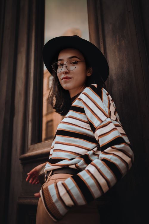 Free Portrait of a fashionable woman wearing a hat and glasses standing in Istanbul. Stock Photo