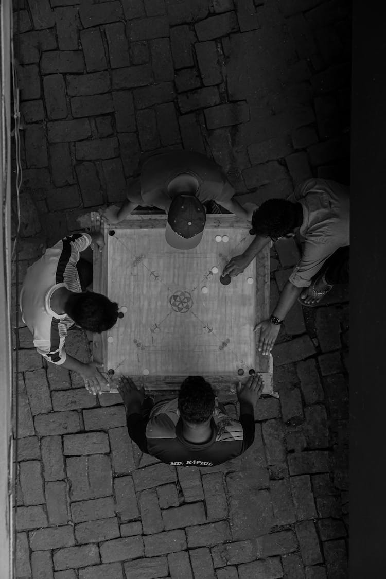 Top View Of Men Standing Around The Table And Playing A Game 