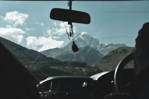 View of stunning mountain landscape through a car windshield. Perfect for travel and adventure themes.
