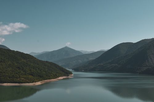 Free Peaceful summer view of mountains and a calm lake under a clear sky. Stock Photo
