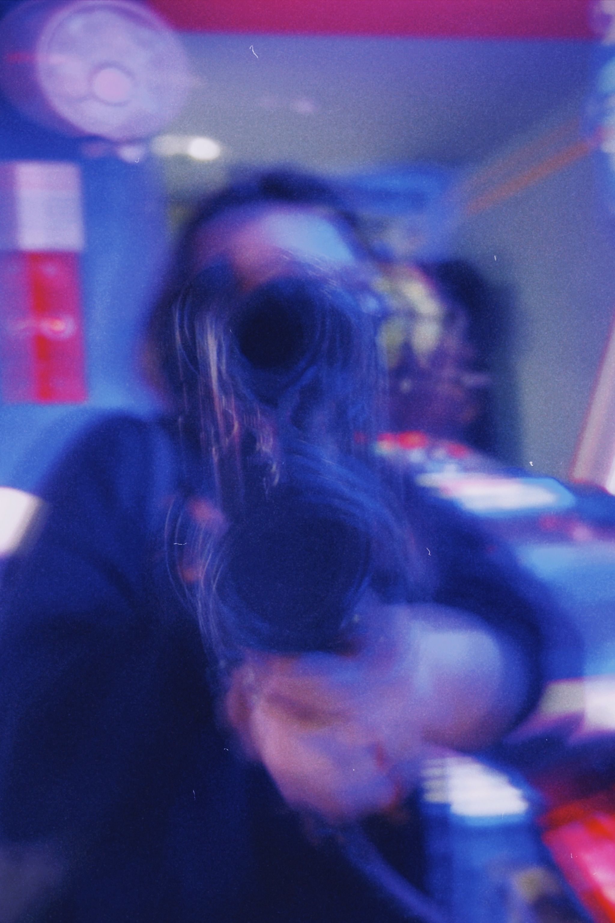 A dynamic abstract photo with blurred motion featuring vibrant colors and an indistinct figure.