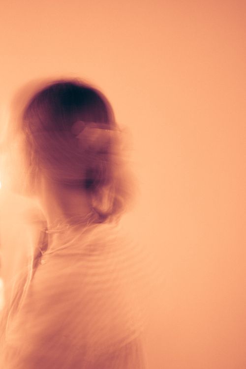 Free Blurred motion image of a person with defocused face and warm tones. Stock Photo