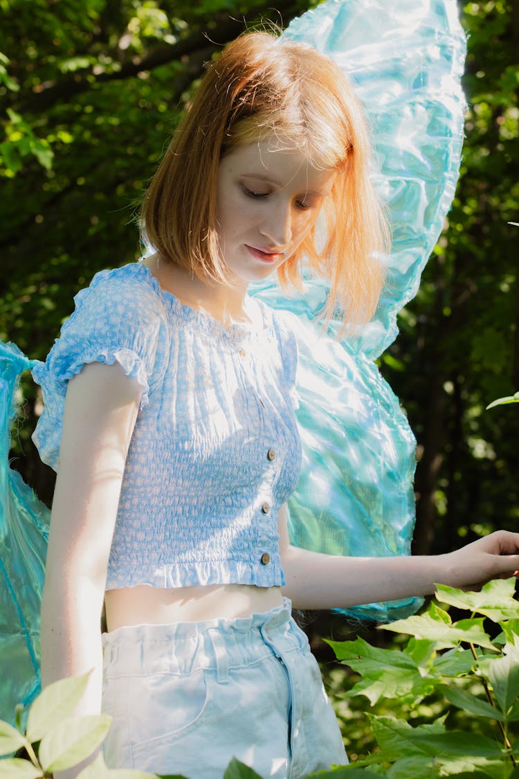 Woman Wearing Butterfly Costume In A Park