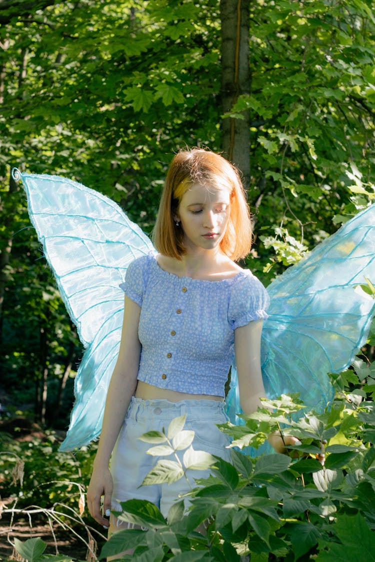 Woman Wearing Butterfly Costume In Park