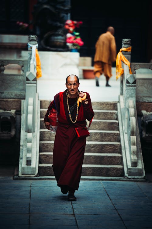 A Monk Walking on the Pavement 