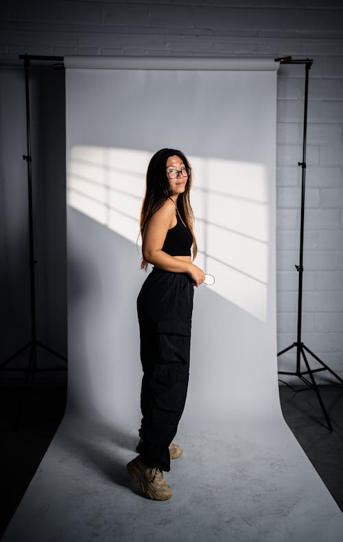 Woman Wearing Black Dress in Studio 