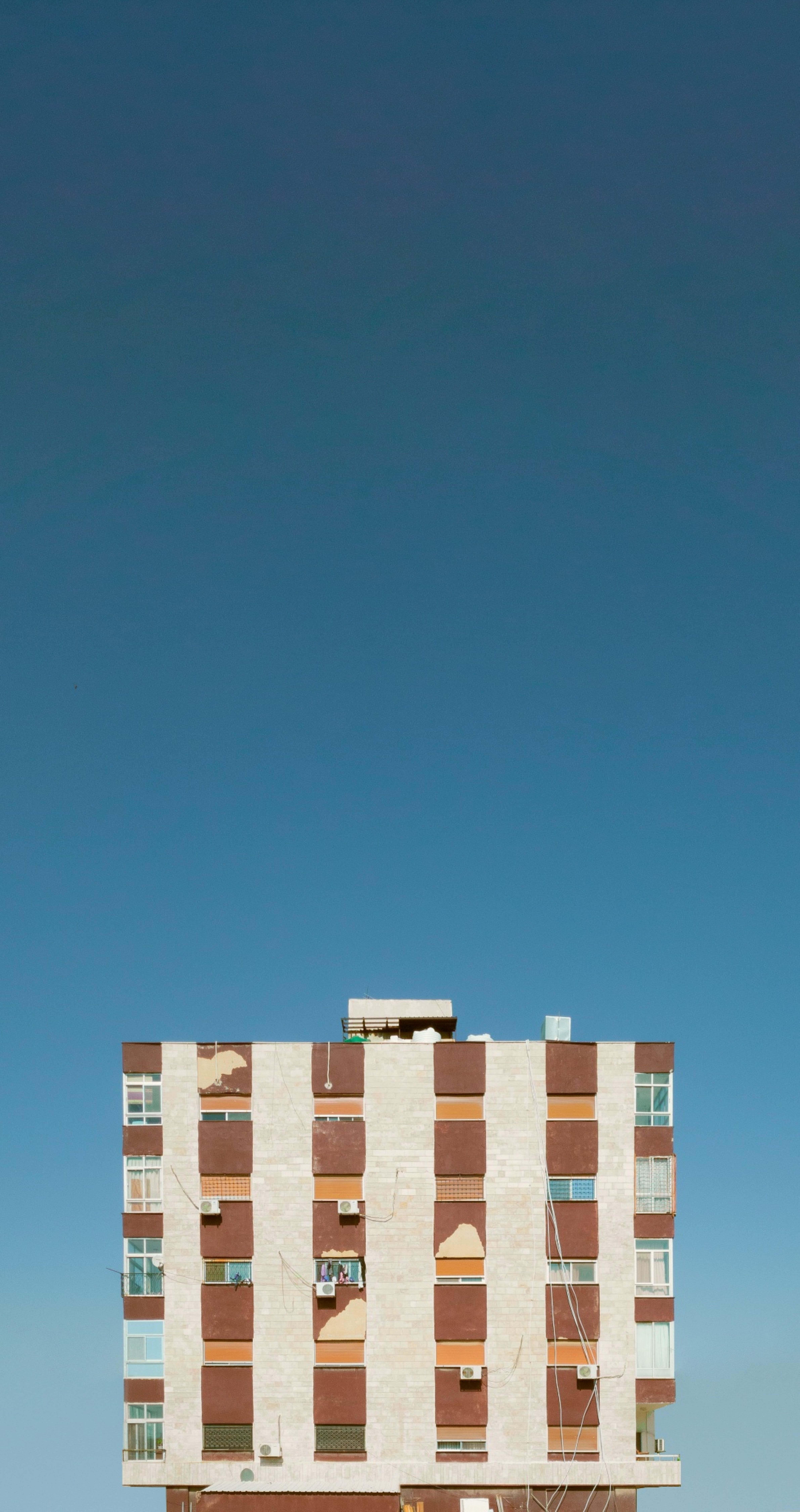 Facade of a Residential Building against a Blue Sky · Free Stock Photo