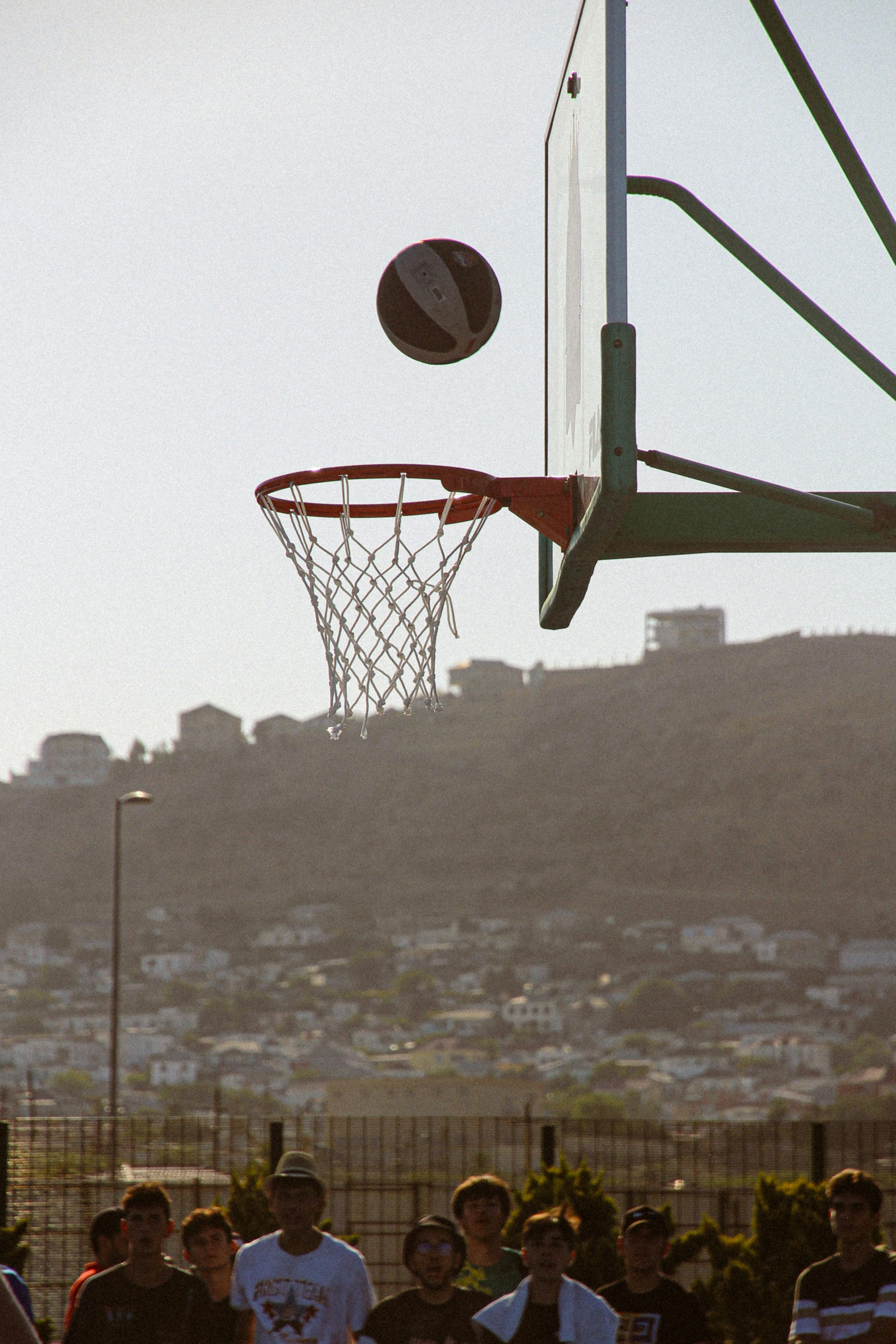 Basketball game with hoop, ball, and spectators in Baku, Azerbaijan.