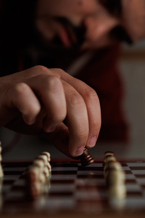 Man Hand over Chess Board