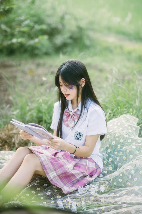 Woman Sitting with Book on Picnic