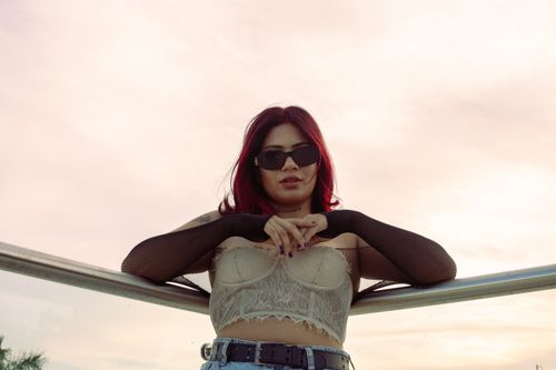 Free Chic fashion portrait of a woman with red hair and sunglasses outdoors in Mérida, Mexico. Stock Photo