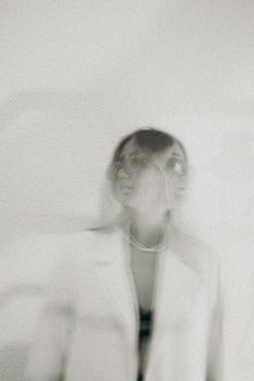 Creative blurred photo of a woman with artistic effect, emphasizing emotion.