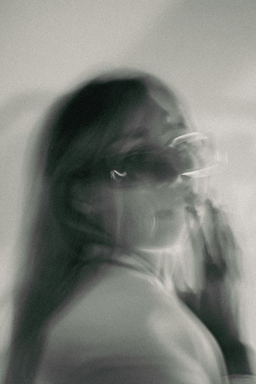 Free A creative black and white portrait featuring blurred motion for an artistic effect. Stock Photo