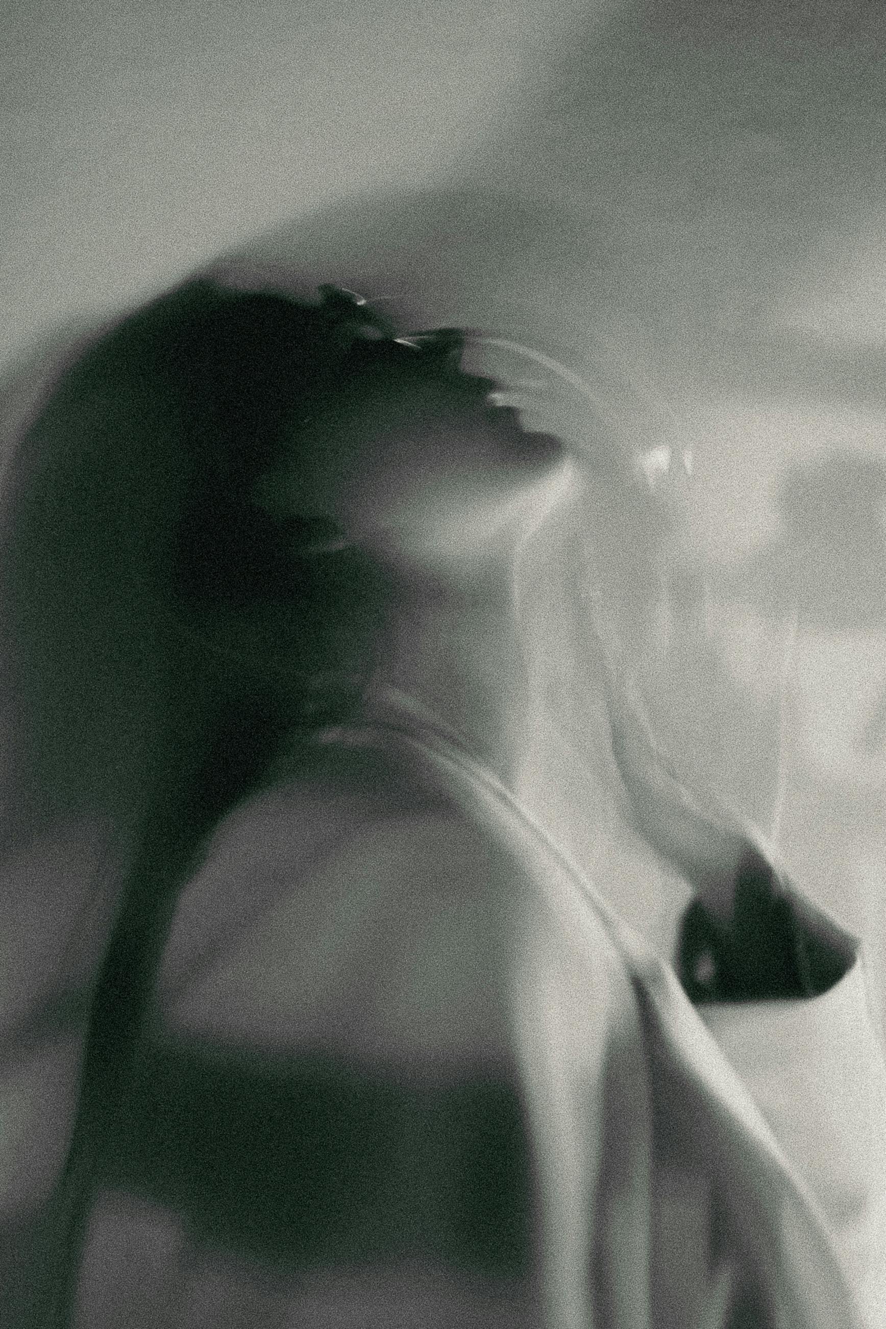 Creative black and white portrait of a woman with a blurred motion effect.