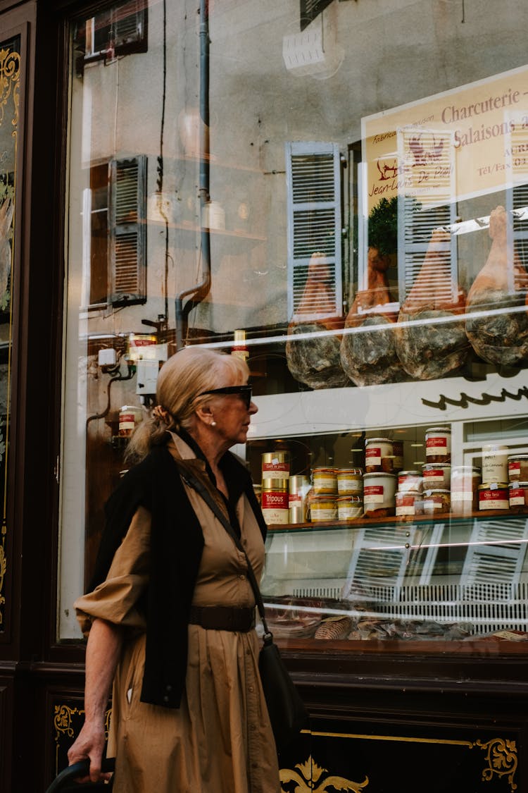 Woman Standing Near Window Of Butchers Shop