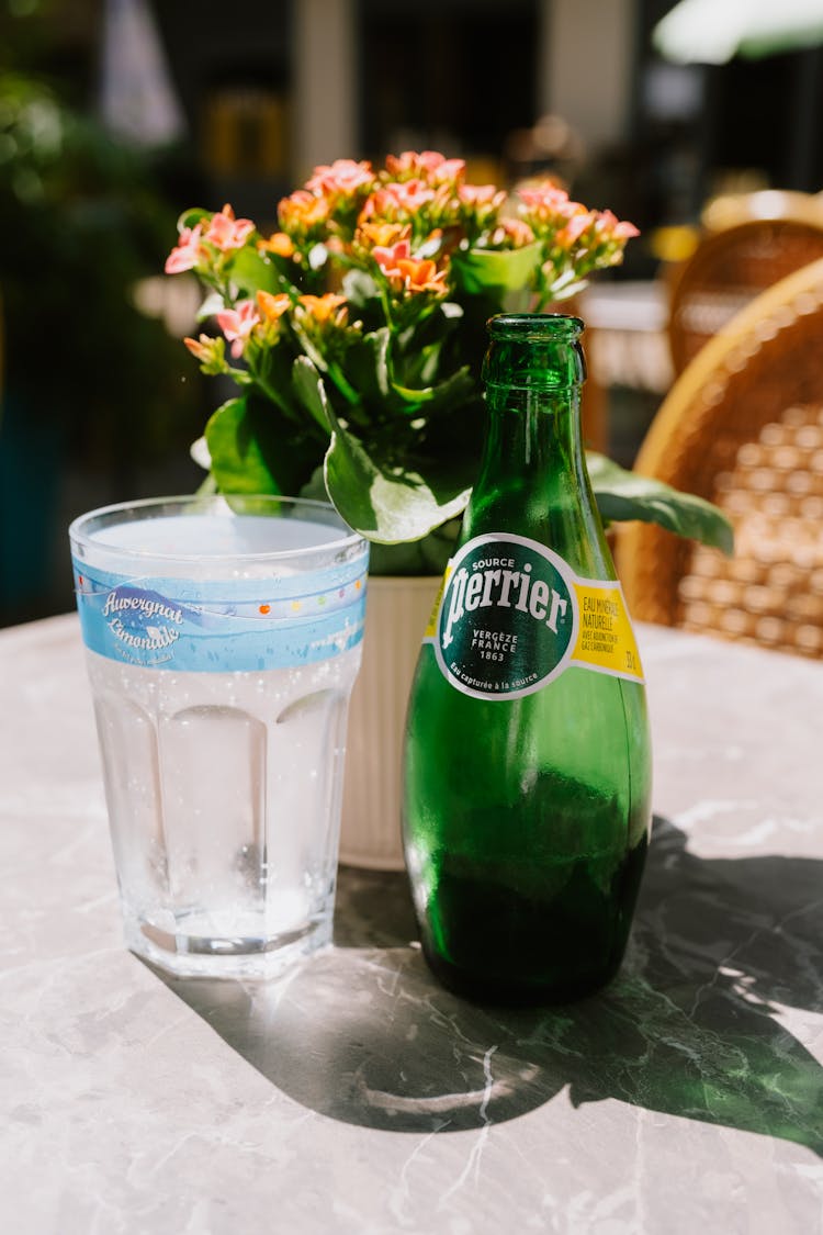 A Glass And Bottle Of Water On The Table At The Restaurant 