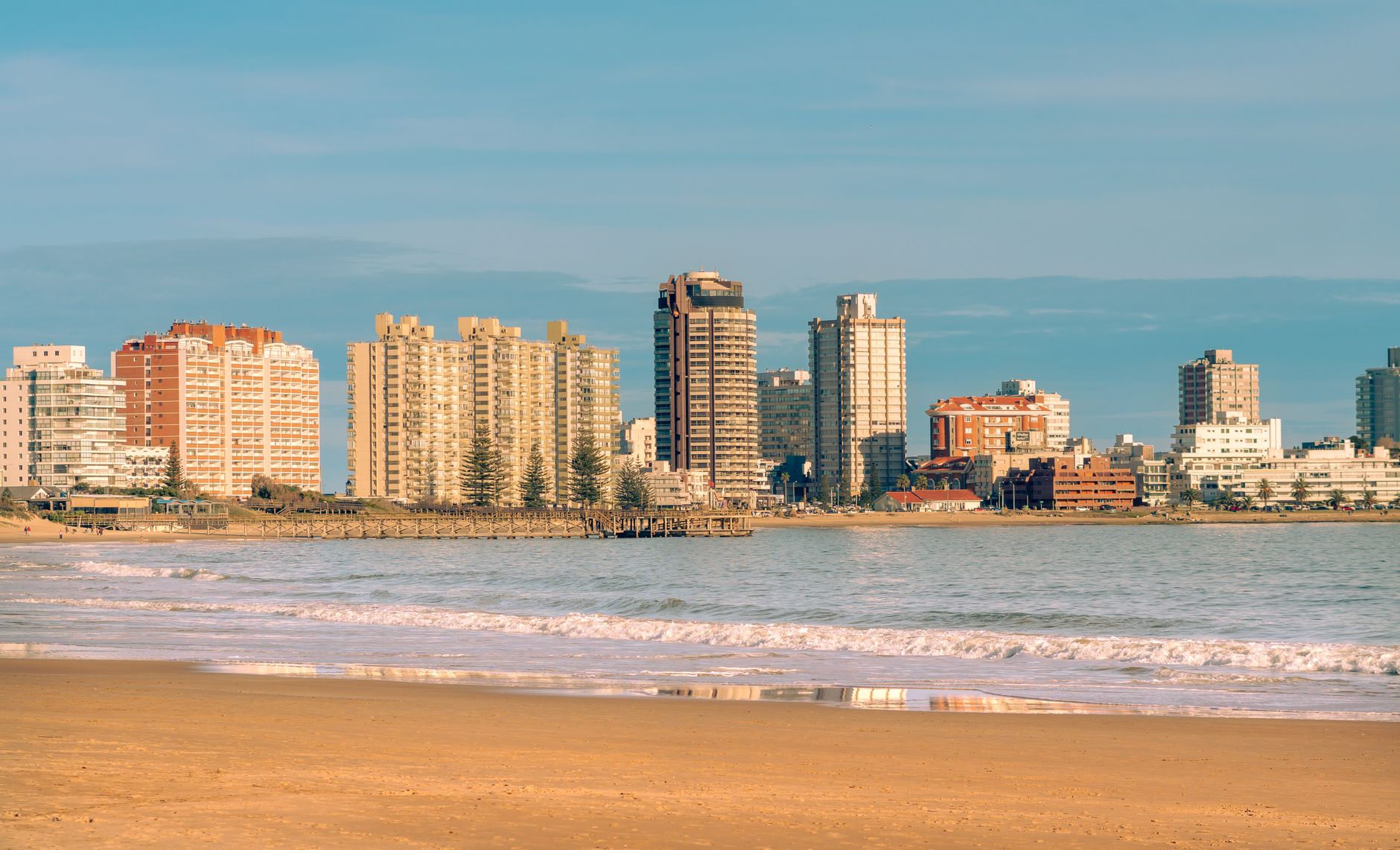 Scenic view of Punta del Este skyline along Playa Mansa beach at sunset, Uruguay's premier resort city.