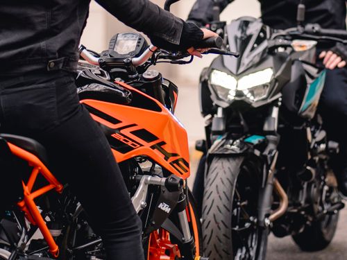 Free Two motorcyclists on high-performance street bikes in a dynamic urban scene. Stock Photo