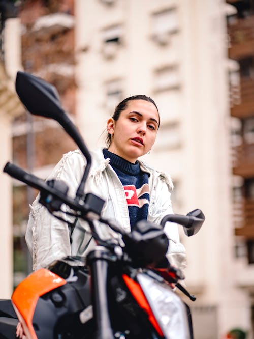 Pretty Brunette Woman in Jacket Posing by Motorcycle