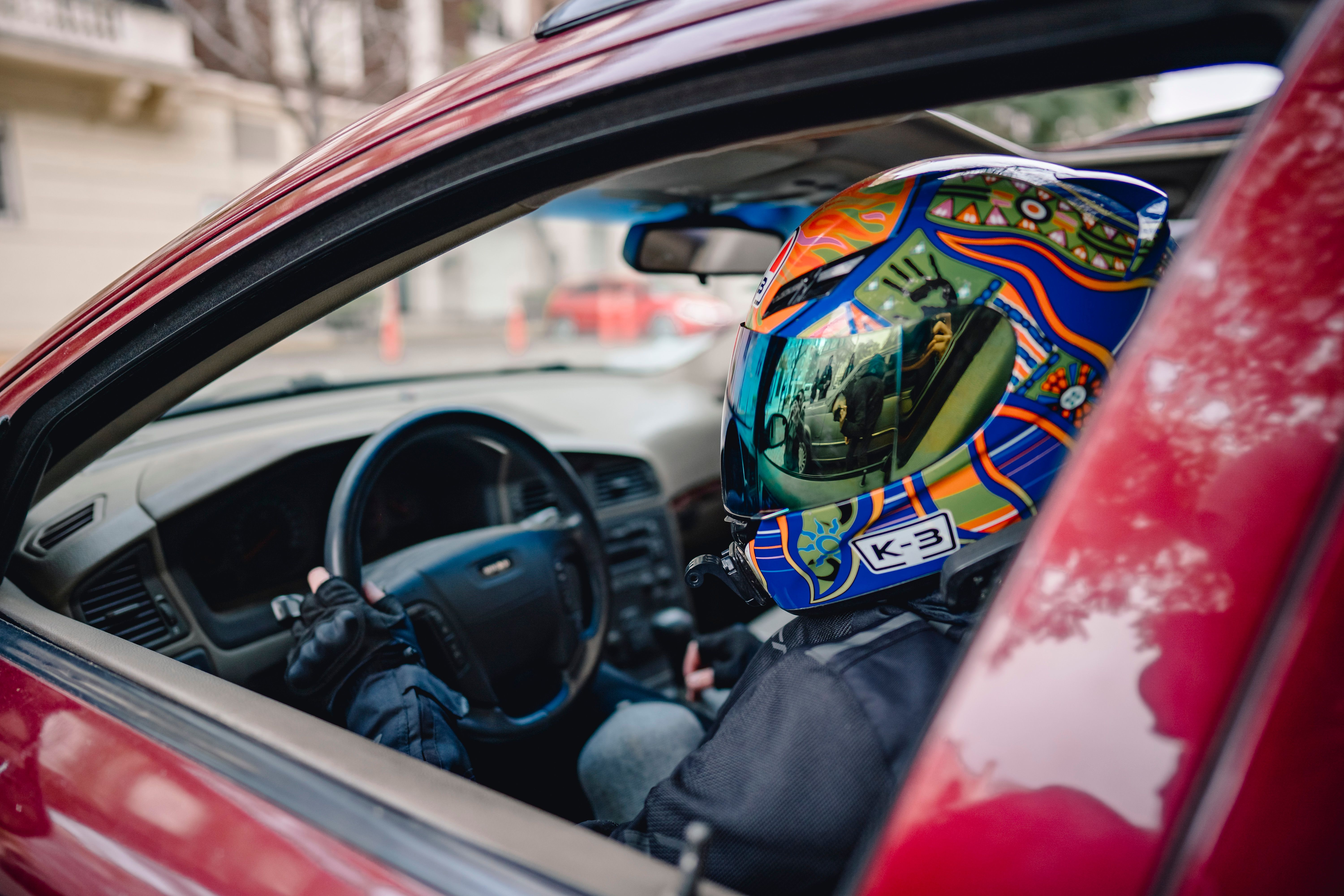 Car keys on a table with a blurred background of a car and driver