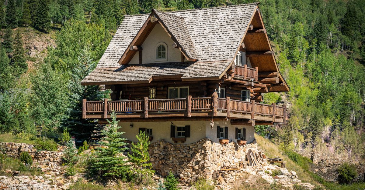 Charming log cabin nestled in the lush, mountainous landscape of Vail, Colorado.