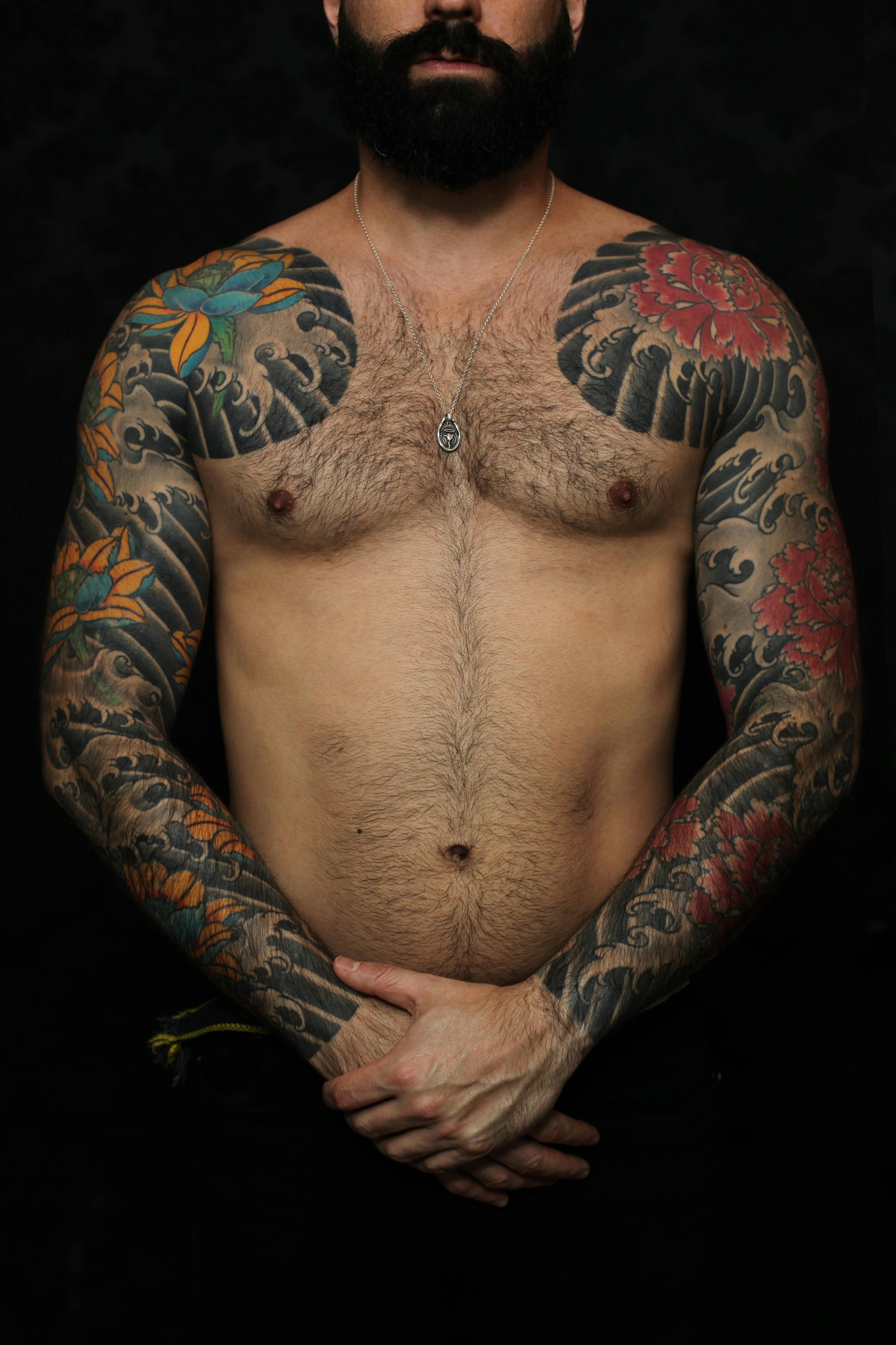 Studio Shot of a Shirtless Man with Arm Tattoos · Free Stock Photo