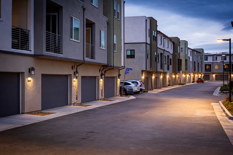 Townhouse development at dusk with exterior lighting switched on