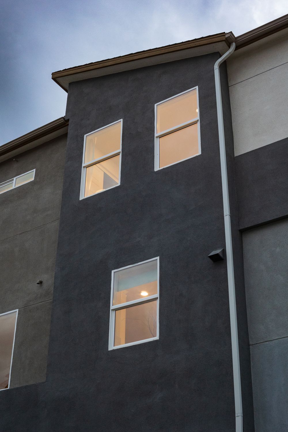 Modern residential facade lit from within at dusk