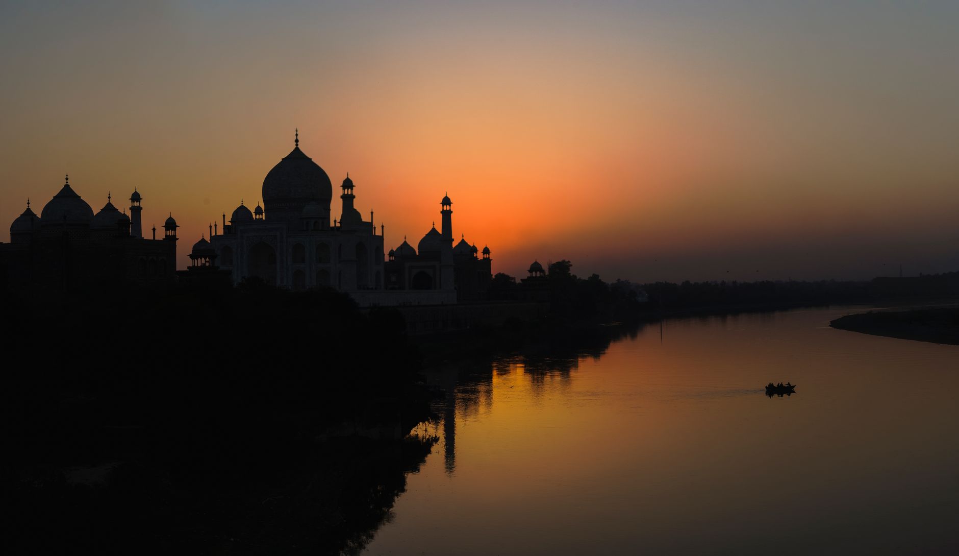 The iconic Taj Mahal in Agra, India, captured at sunset showcasing its majestic architecture.
