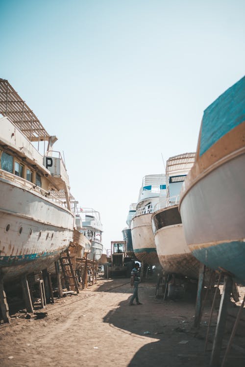 Man Standing Near White Ships