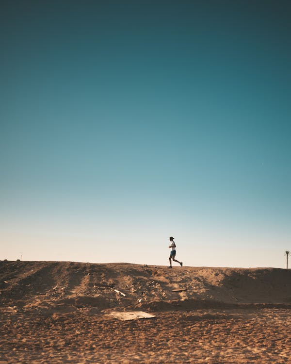 Free Photo of Person Running on Dirt Road Stock Photo